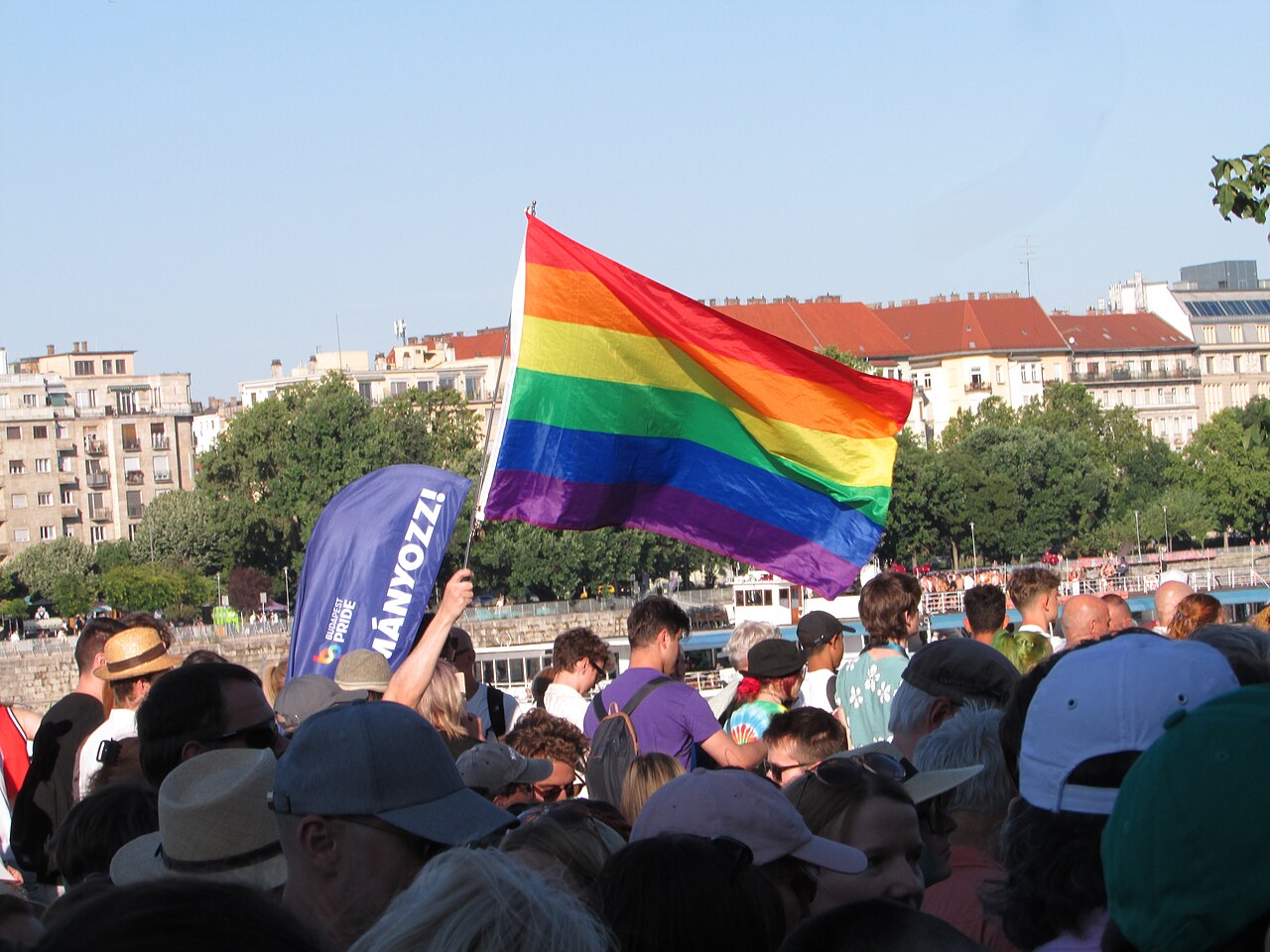 Rainbow flag above the crowd at Budapest Pride 2025