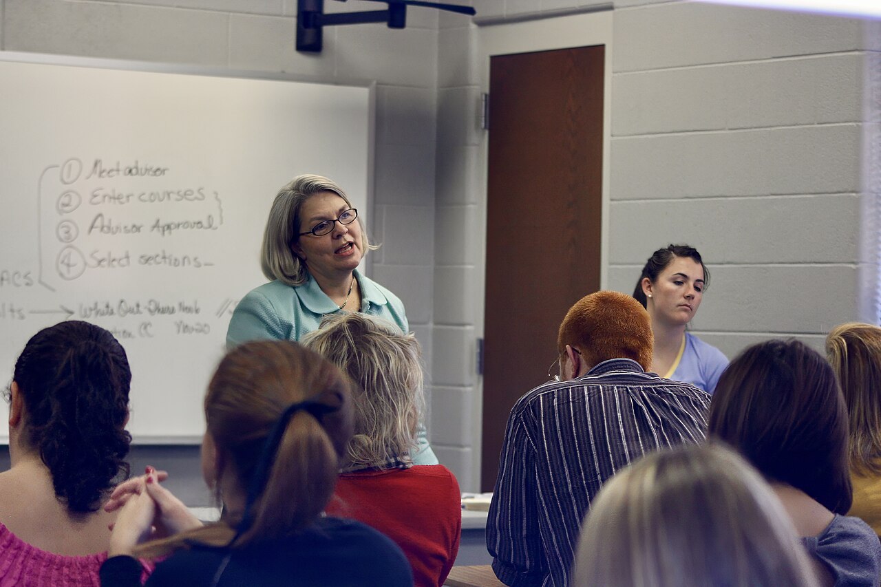A college professor teaching in a university classroom full of students in Tennessee, United States 11