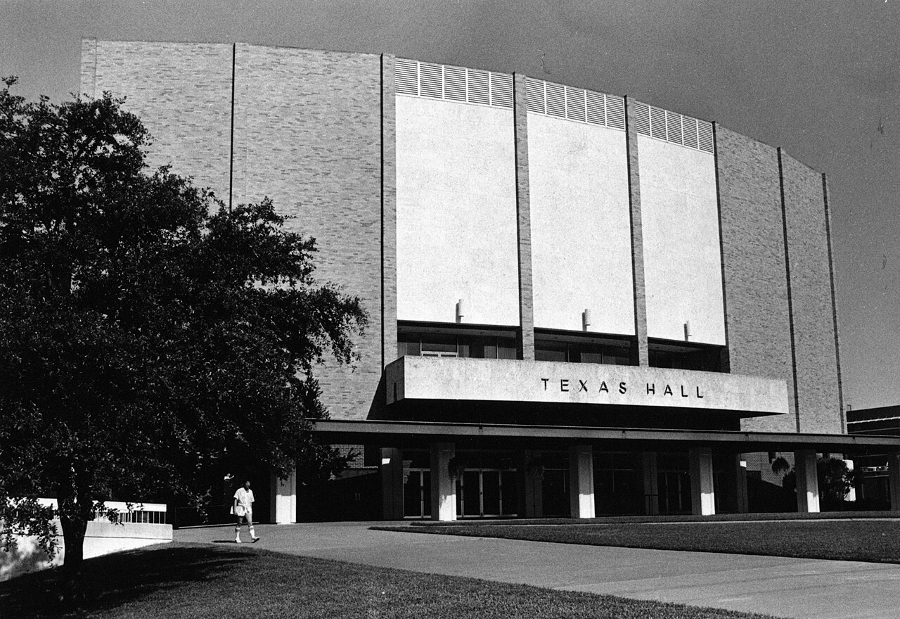 Student walking near newly constructed Texas Hall auditorium, Arlington State College campus (10008781)