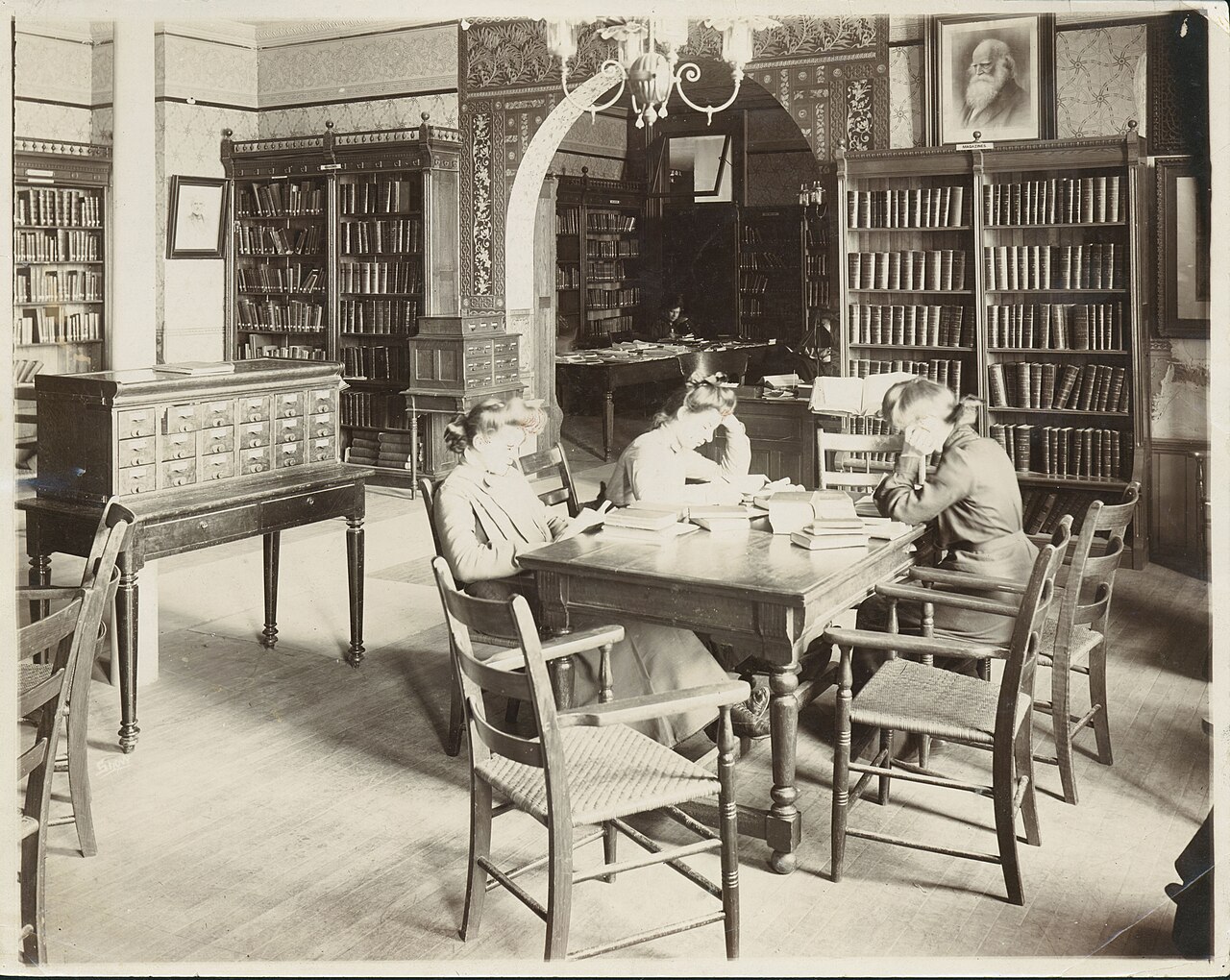 Three female students studying in the library at Mankato State Normal School, Mankato, Minnesota - DPLA - 0704