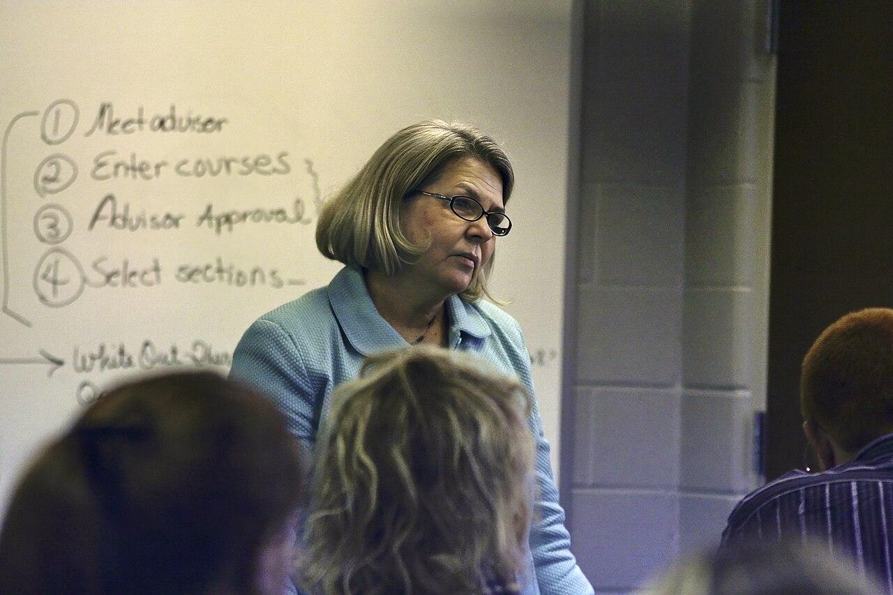 A college professor teaching in a university classroom full of students in Tennessee, United States 13